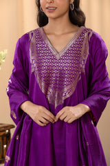 A woman in a traditional purple salwar suit and purple banarasi dupatta close view