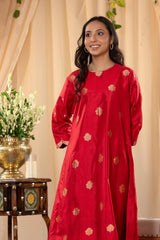 A woman in a traditional red salwar suit and red banarasi dupatta