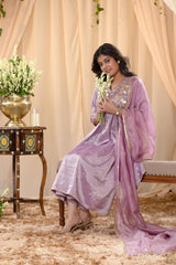 A woman in a traditional lilac pink salwar suit and lilac banarasi dupatta