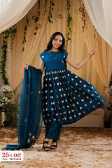 Woman in a blue traditional outfit with a decorative backdrop