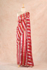 Red and white striped saree on a mannequin against a beige background