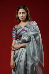 Woman wearing a colorful Party Wear saree against a red background