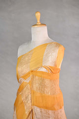 yellow gold and silver checkered organza silk tissue saree draped on a mannequin against a gray background
