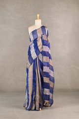 Blue gold and silver checkered organza silk tissue saree draped on a mannequin against a gray background