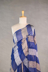 Blue gold and silver checkered organza silk tissue saree draped on a mannequin against a gray background