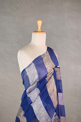 Blue gold and silver checkered organza silk tissue saree draped on a mannequin against a gray background