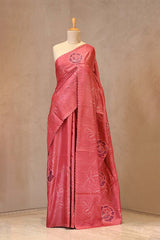 Close up of Rust Red Applique Tussar Silk Saree showing contrast floral applique work and pitta zari woven floral border.