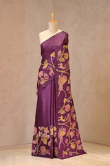 Close up of Deep Purple Tussar Silk Saree showing multicolor shikargah floral applique work on the pallu and pleats with a resham scalloped border.