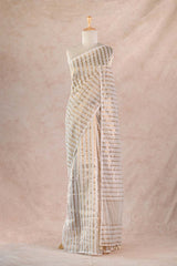 Striped dress on a mannequin against a beige fabric background