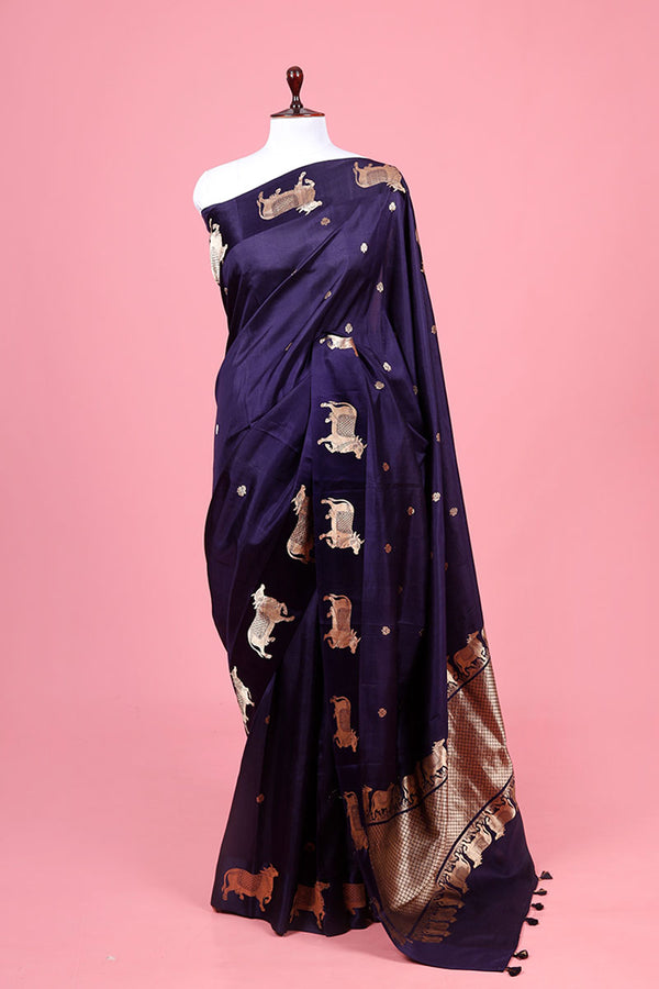 A navy blue Banarasi silk saree with Pichwai border for Navratri, Diwali, Durga Puja, and weddings, displayed on a mannequin. 
