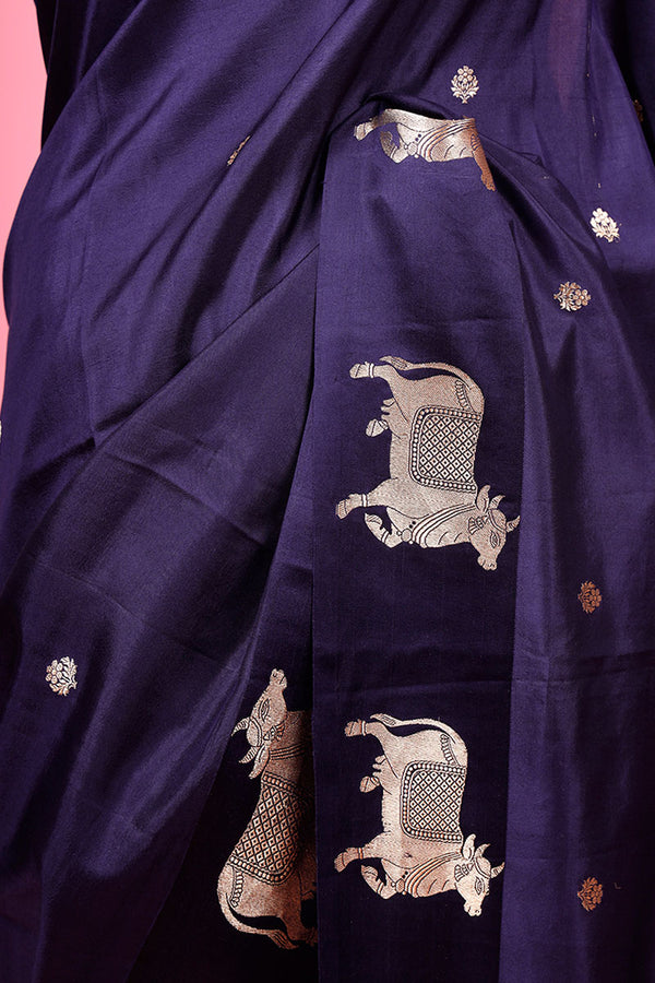A navy blue Banarasi silk saree with Pichwai border closeup shot
