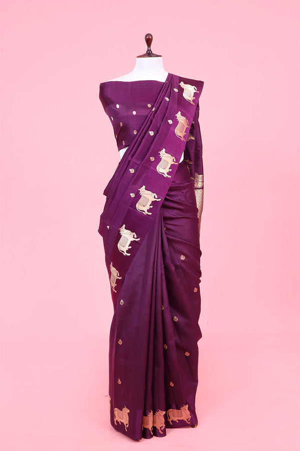 A purple Banarasi silk saree with gold zari border for Navratri, Diwali, Durga Puja, and weddings, displayed on a mannequin. 