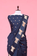 A dark grey Banarasi silk saree with Pichwai border for Navratri, Diwali, Durga Puja, and weddings, displayed on a mannequin. 