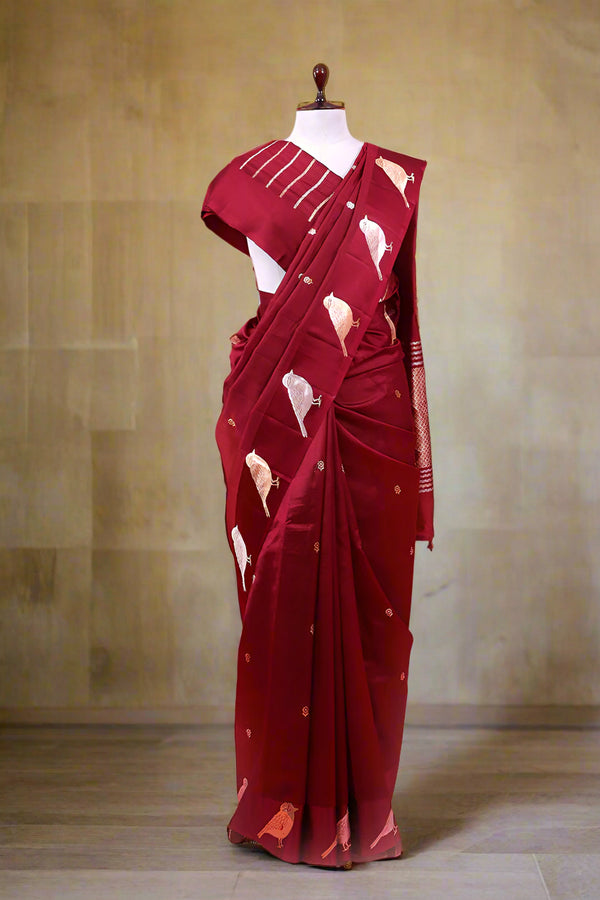 A maroon silk saree draped like Nita Ambani style on a mannequin
