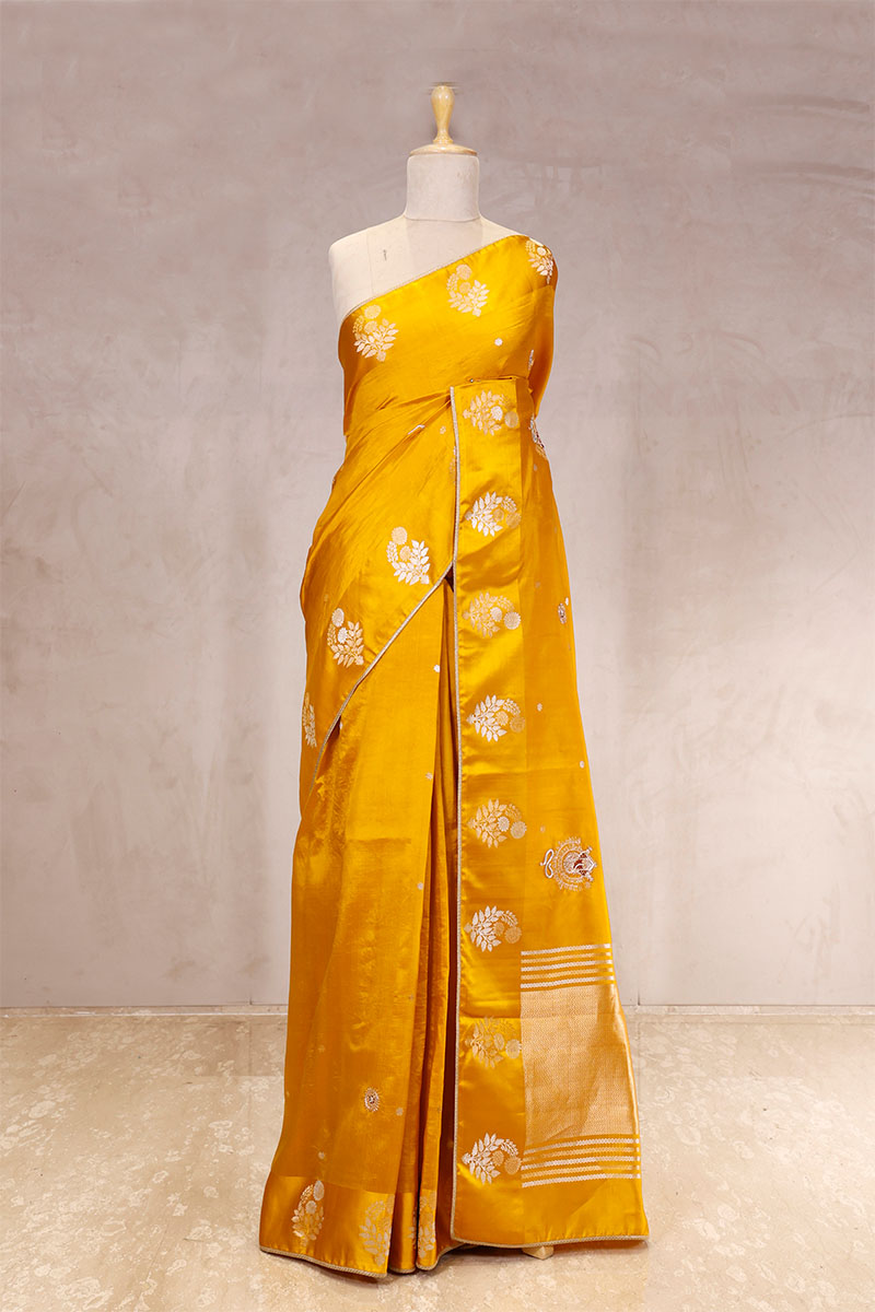 This Yellow Handloom Banarasi Silk Saree with Ganesh Mantra Embellished Pallu is a wedding saree and festive wear saree. Free Shipping Available!