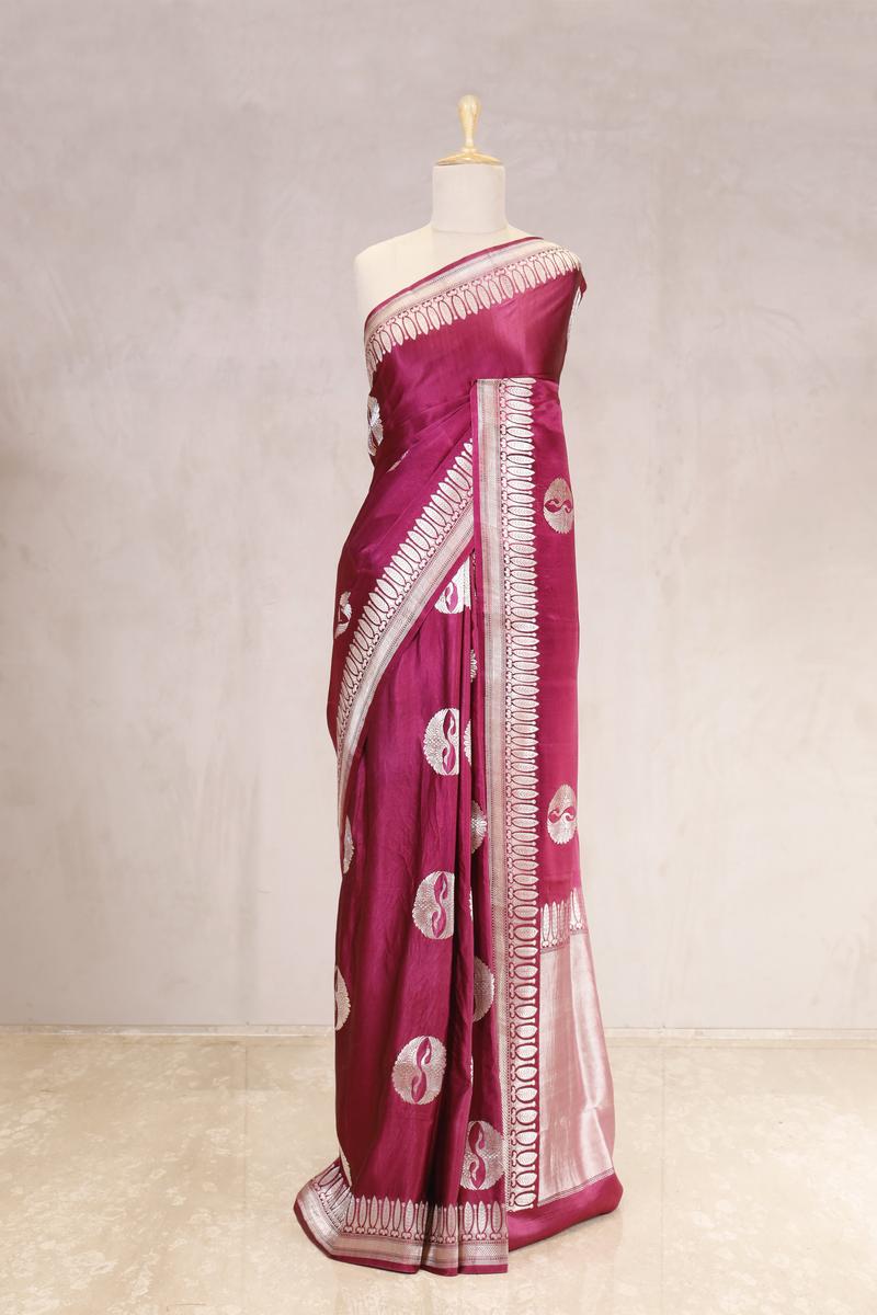 This Magenta Handloom Banarasi Satin Silk Saree with Silver Zari Work is a wedding saree and festive wear saree. Free Shipping Available!