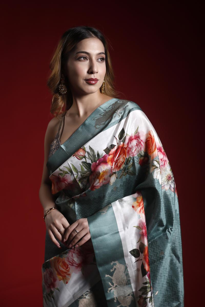 A woman wearing a floral party wear saree against a red background