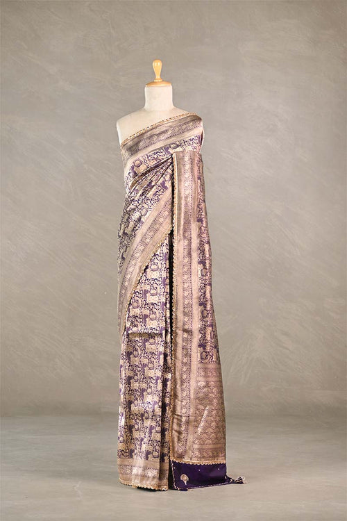 Purple Saree draped over a mannequin against a plain background
