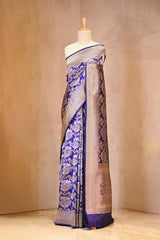 A purple shikargh Banarasi silk saree on dummy