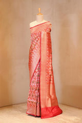 A red shikargah Banarasi silk saree on dummy