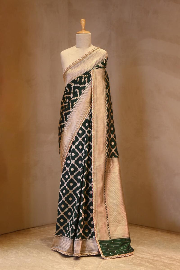 A green Banarasi Silk saree with crisscross pattern on dummy