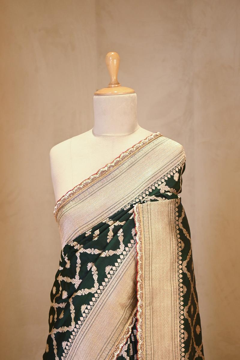 A green Banarasi Silk saree with crisscross pattern on dummy