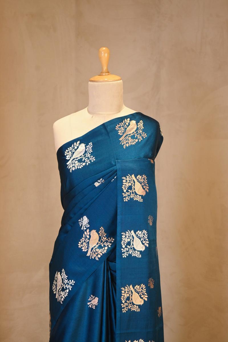 A blue Banarasi silk saree with zari motifs on dummy