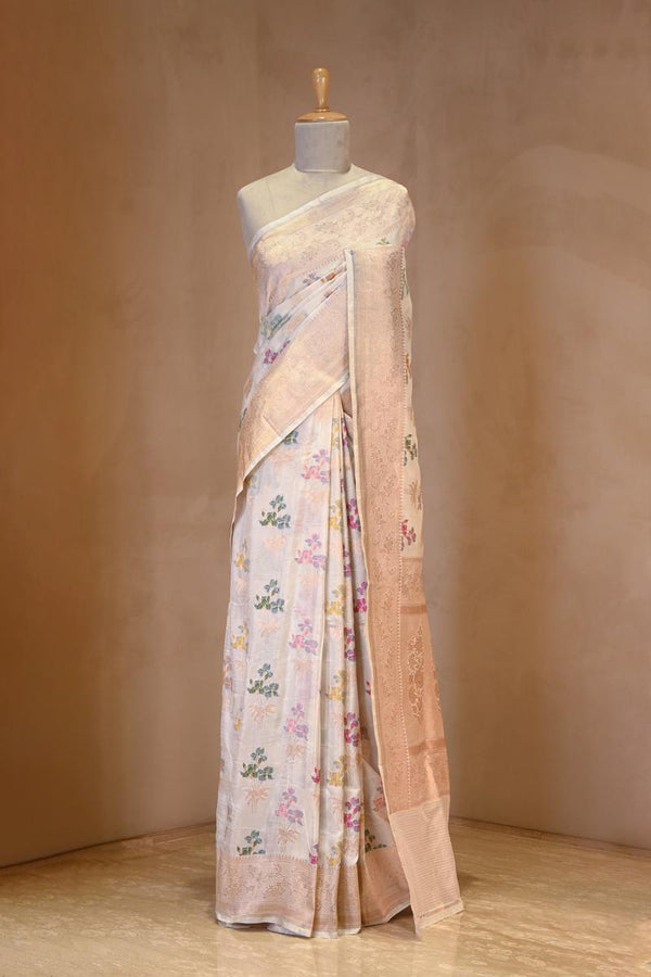 A White banarasi silk saree with multicolor floral work on dummy
