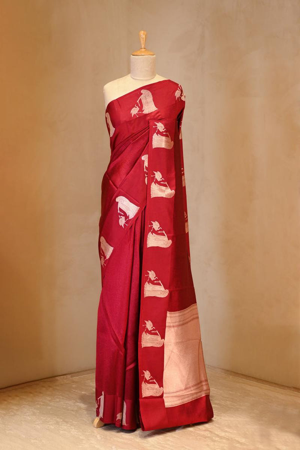 A red banarasi silk saree on dummy