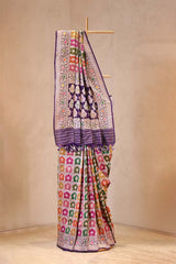Colorful saree with intricate patterns on a beige background