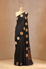 Black Puna Banarasi silk saree featuring gold zari checkered body, mayur motif border.