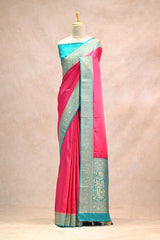 Saree with pink and blue colors on a mannequin against a beige background