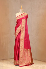 Close up of Pink Semi Satin Silk Saree showing gold zari woven polka butis and a Paithani-style Meenakari border.