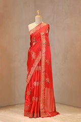 Close up of Red Semi Satin Silk Saree showing gold zari floral vines in a diagonal Leheriya pattern with resham woven pakshi motifs.