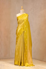 Close up of Light Green Semi Viscose Silk Saree showing gold zari wave brocade pattern on the body and satin border with Pichwai motifs.