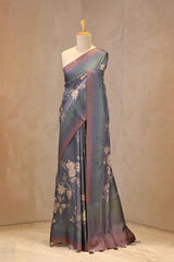 Close up of Steel Blue Semi Silk Saree showing digital floral prints across the body and plain shaded border with zari stripes on the pallu.