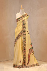 Close up of Yellow Kota Check Saree showing Mayur Kalamkari printed applique motifs on the body and floral printed borders.