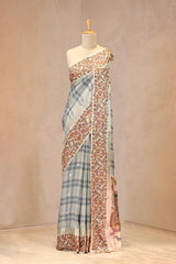 Close up of Sky Blue Semi-Silk Saree showing shaded checkered body, scattered water gold zari butis, and Kalamkari printed border.
