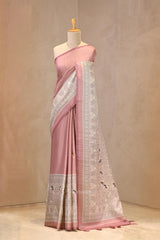 Close up of Nude Pink Semi-Silk Saree showing water gold zari butis on the body and a Madhubani printed border featuring folk-art figures.