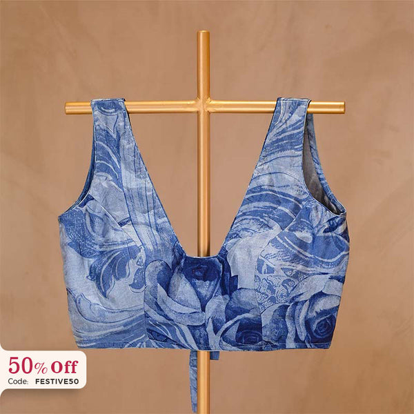 Blue floral-patterned top on a gold rack with a beige background and 40% off label.