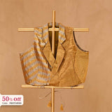A golden silk top blouse on a gold stand with a 50% off promotional label 