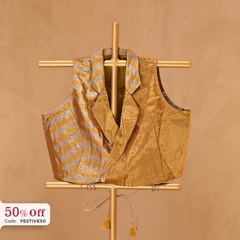 A golden silk top blouse on a gold stand with a 50% off promotional label 