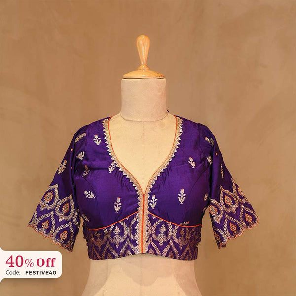 A Purple embroidered blouse on a mannequin with a promotional text Diwali sale offer on blouses up to 50%