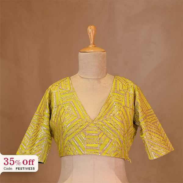 Yellow embroidered blouse on a mannequin with a promotional text Diwali sale offer on blouses up to 50%