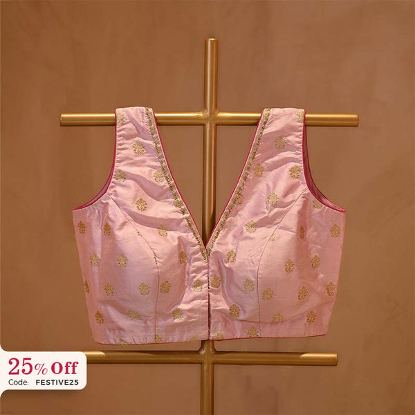 Pink embroidered top on a gold stand with a promotional text Diwali sale offer on blouses up to 50%