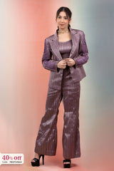 Woman wearing a purple patterned suit with a gradient background