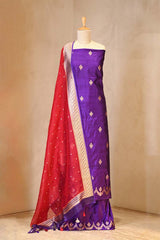 Red and purple saree with white border on a mannequin against a beige background