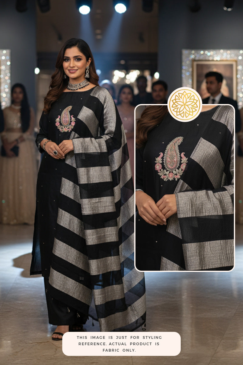 Woman wearing a black Banarasi silk suit set, indoor party celebration setting.