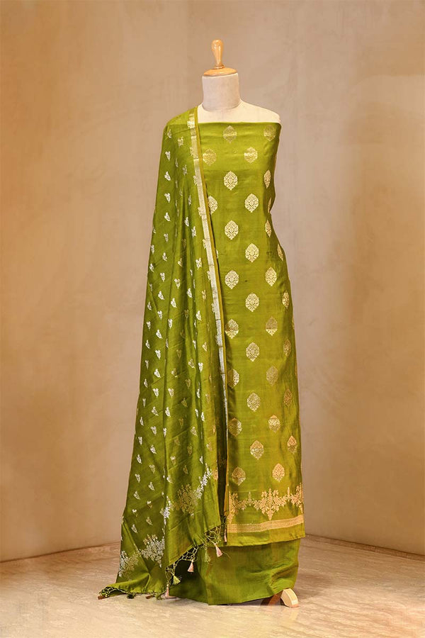 Green saree with floral patterns on a mannequin against a beige background
