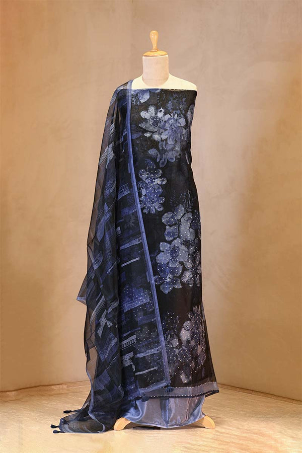 Blue floral patterned fabric draped over a mannequin against a beige background
